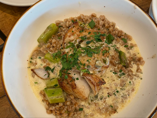 a bowl of Icelandic cod with faro, asparagus and cream sauce.