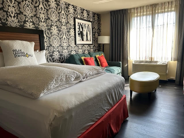 One of two plush queen-sized beds and a reception area in the hotel's junior suite.