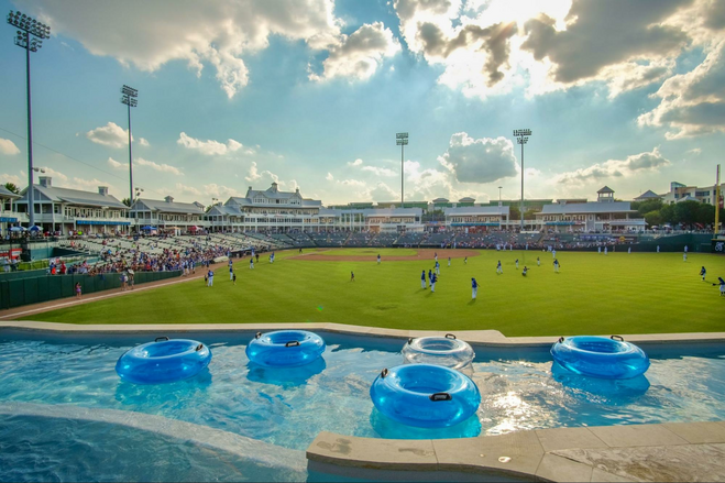 Lazy River with blue inner tubes in the outfield at Riders Field, a minor league baseball stadium in Frisco, Texas
