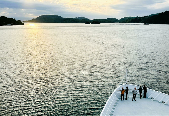 Guests on bow of Pollux view scenery.