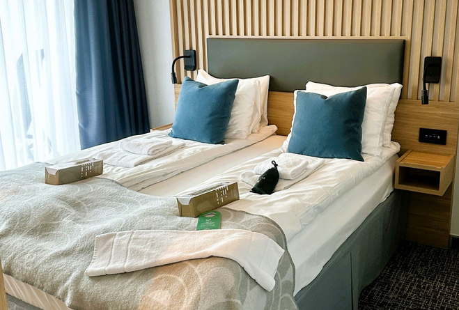 Bedroom in a suite aboard the Pollux cruise ship.