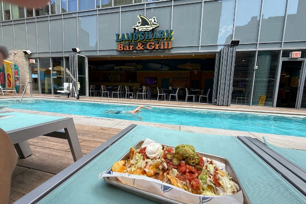 Giant nachos plate and pool near Landshark Bar & Grill, Margaritaville Resort Times Square, NYC.