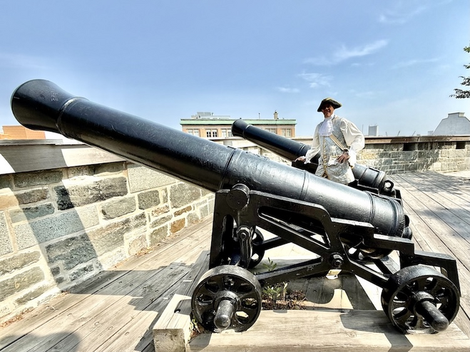 Guide Sylvain Girard stands by historic cannons on Old Quebec’s walls, an idyllic couple's getaway