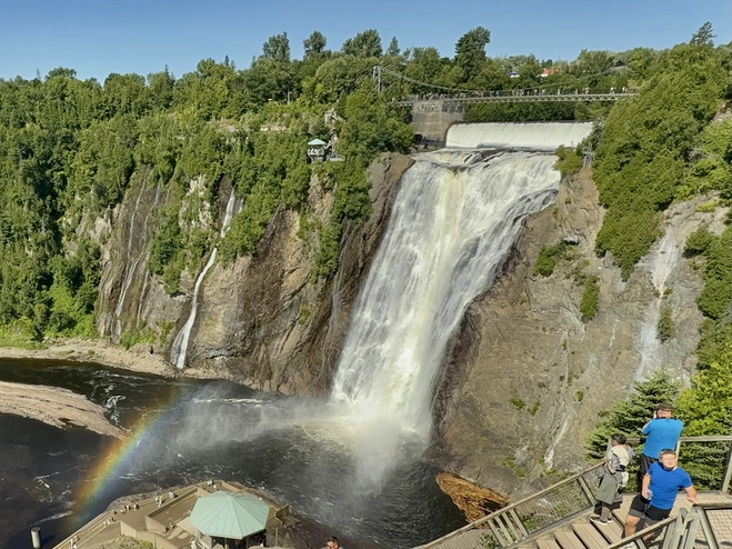 Montmorency Falls, taller than Niagara Falls, with bridge and stairs for viewing, a stunning spot for couples to enjoy a romantic Quebec City escape.