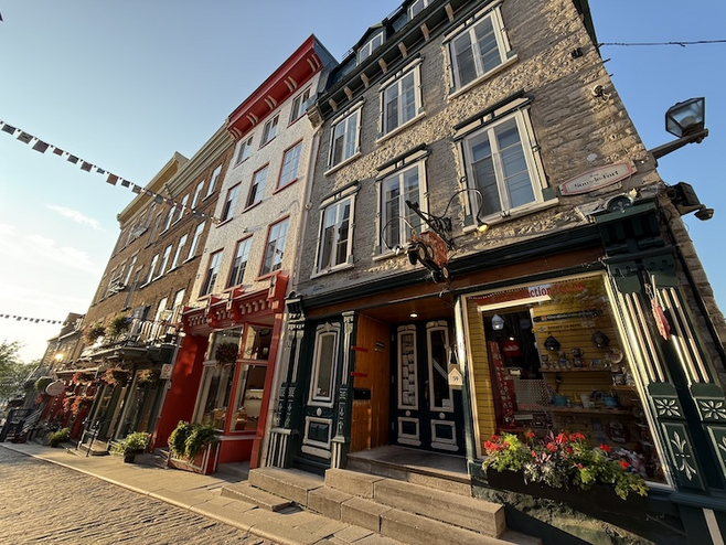 Charming shops along Sous-le-Fort in Old Quebec, a picturesque stroll for couples enjoying a romantic break.
