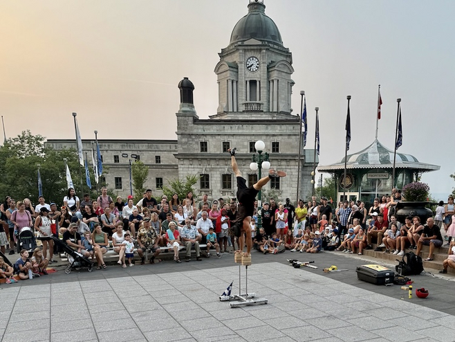 Street performer entertaining visitors on Dufferin Terrace, a lively spot for couples soaking in the charm and romance of Quebec City.