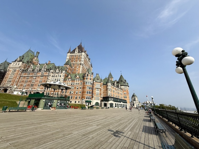 Château Frontenac and Dufferin Terrace overlooking the St. Lawrence River, surrounded by historic charm in Quebec City.