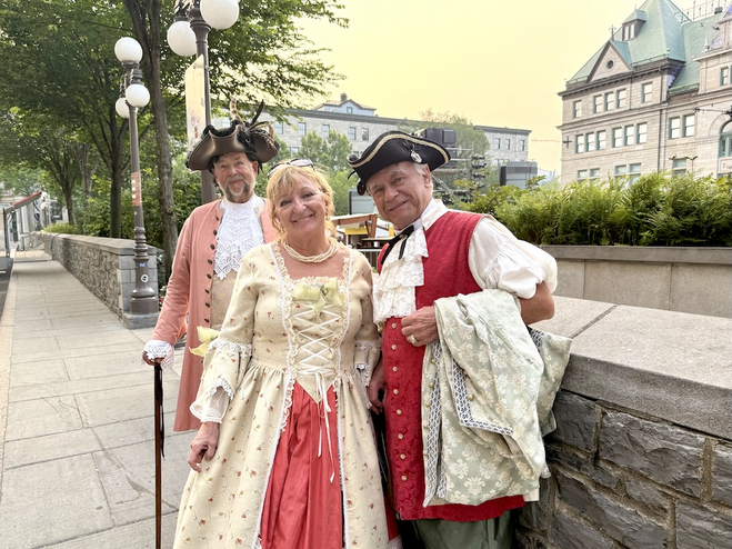 Revelers in period dress at Fêtes de la Nouvelle-France in historic Quebec City.