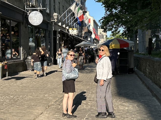 Woman with guide on Rue Sainte-Anne in Old Quebec, a destination for romance.
