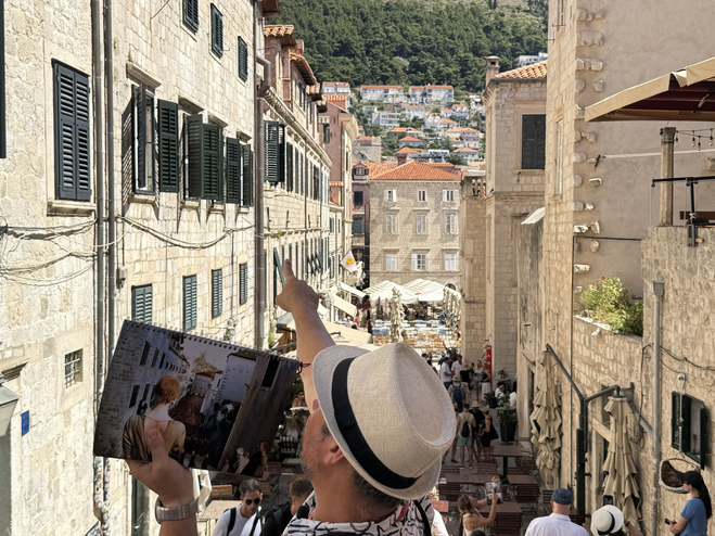 Tour guide pointing out points of interest where the Game of Thrones Walk of Shame was filmed on Dubrovnik street.
