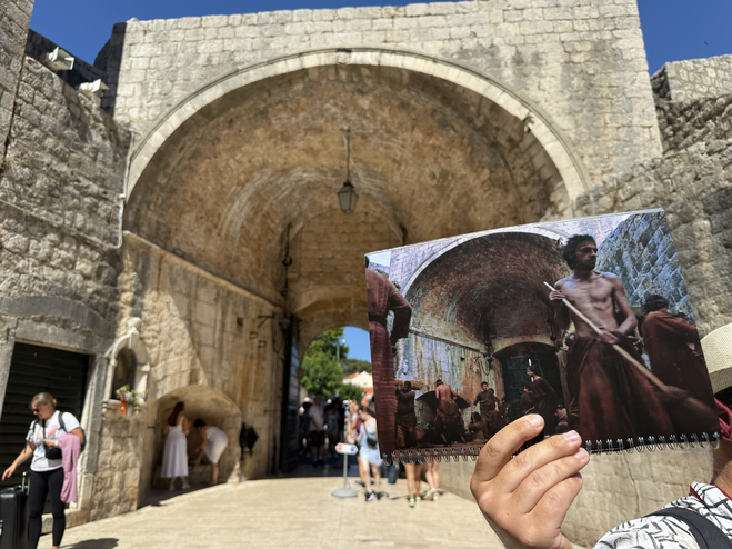 Inside of Dubrovnik's famous Pile Gate with Game of Thrones TV show scene card in foreground.