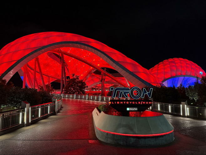 TRON Lightcyle, at night, with red lighting to showcase the upcoming ride overlay.