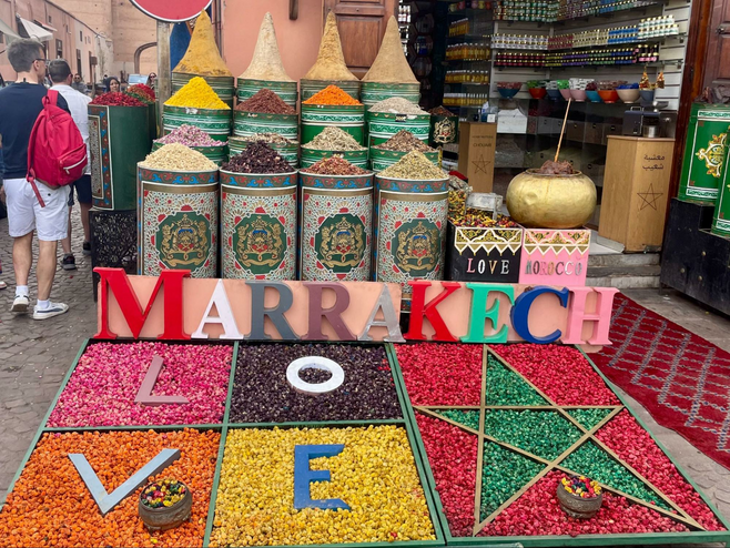 Colorful spices in the market of Marrakech, Morocco, spelling out "Love" and "Marrakech."