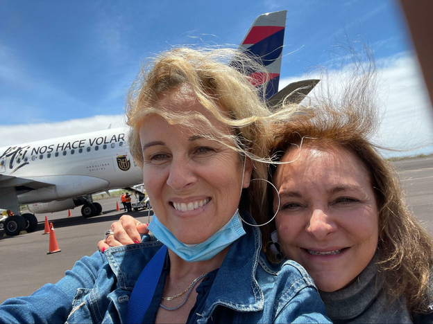 Two women on the tarmac at a regional airport.