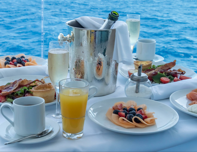 Ultimate Balcony Breakfast on the Sun Princes includes juice, Prosecco, fruit plates, pastries, small quiches, bacon, and salad