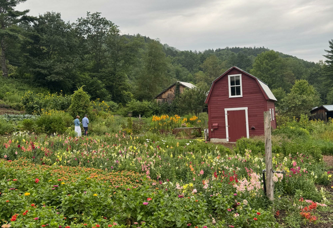 flower gardens and a small barn