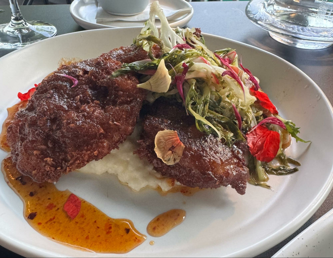 a plate of crispy fried quail with grits