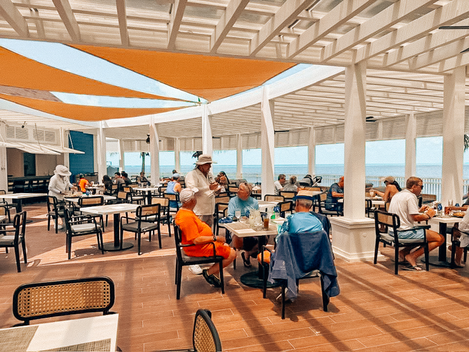 Open air restaurant with people sitting at the tables eating
