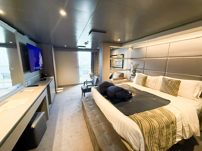 View of cruise ship stateroom from the door showing the bed, dresser and TV