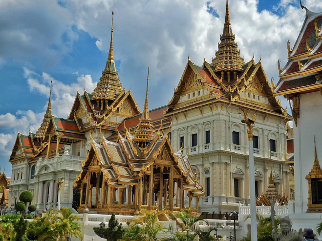 White buildings with intricate red and gold rooftops