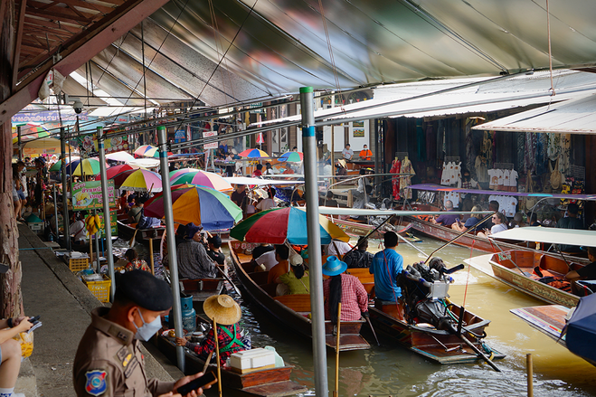 Small river boats with rainbow umbrellas 
