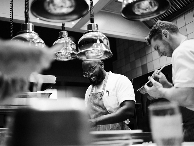 Two chefs working in the kitchen of Nobelhart & Schmutzig, a Berlin Michelin-starred restaurant. 