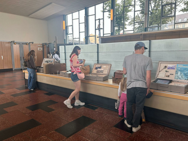 Museumgoers look at the suitcases displayed at the Palace of Tears, a free museum in Berlin, located in the former border crossing of the Friedrichstraße railway station.