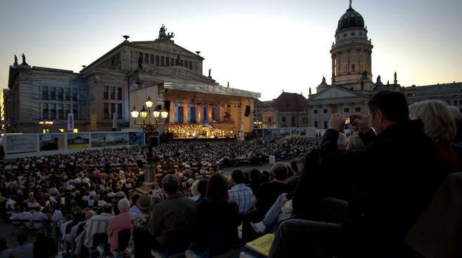 A large audience enjoying an outdoor concert at Classical Open Air at the Gendarmenmarkt, Berlin's most famous square. 
