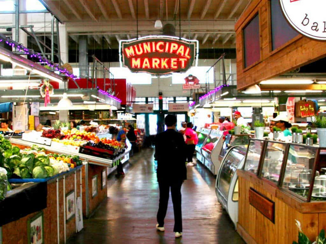 Person walking through the produce aisle of The Municipal Market food hall in Atlanta