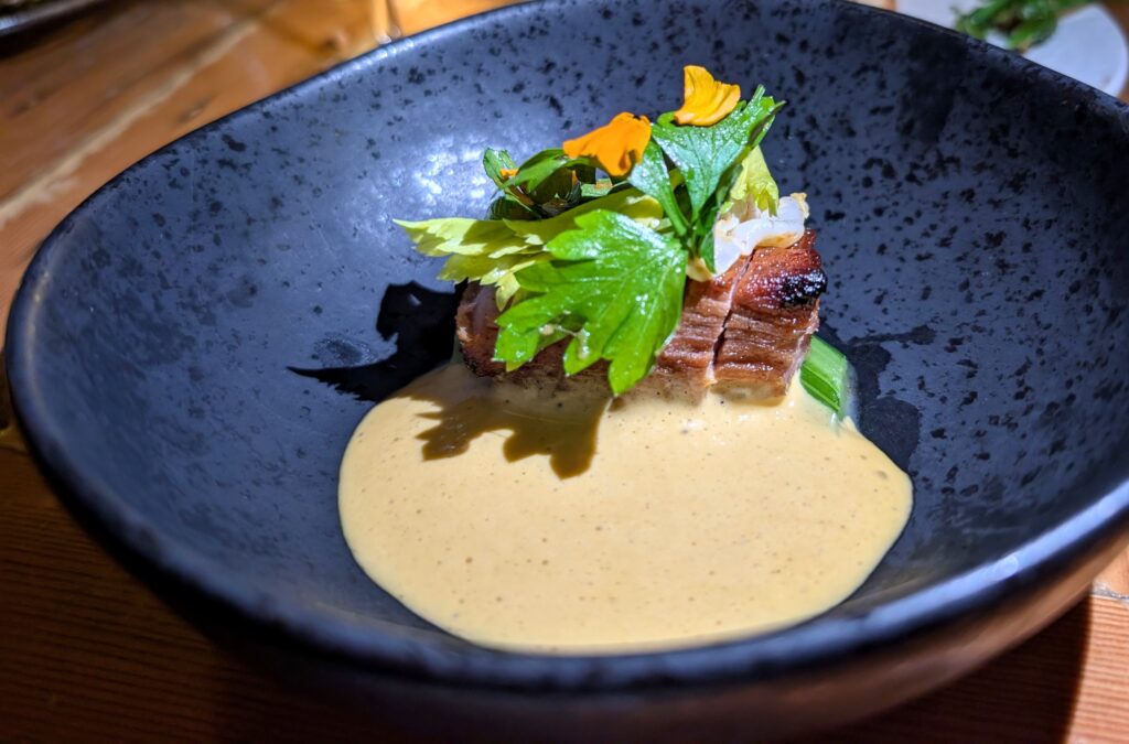 The pork collar with craised celery and spotted shrimp cream, a highlight of the tasting menu at Burdock and Co., a woman-owned, Michelin-starred restaurant in Vancouver.