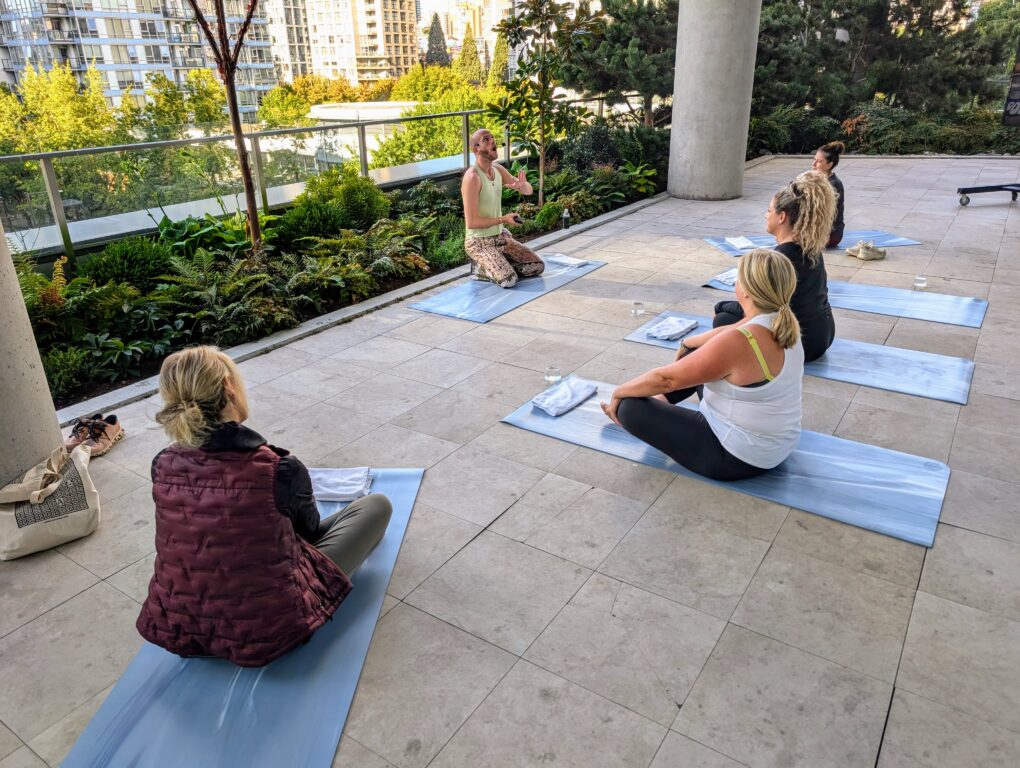 4 women sitting on yoga mats at the JW Marriott Parq Vancouver