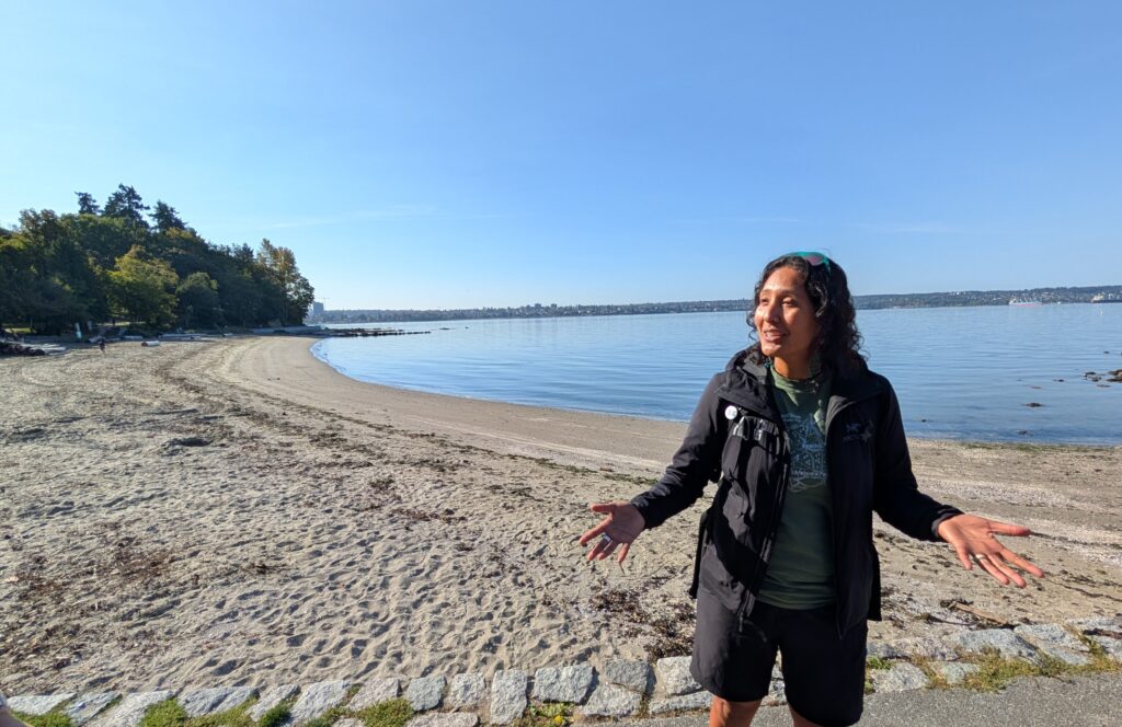 A woman standing on the beach in Vancouver