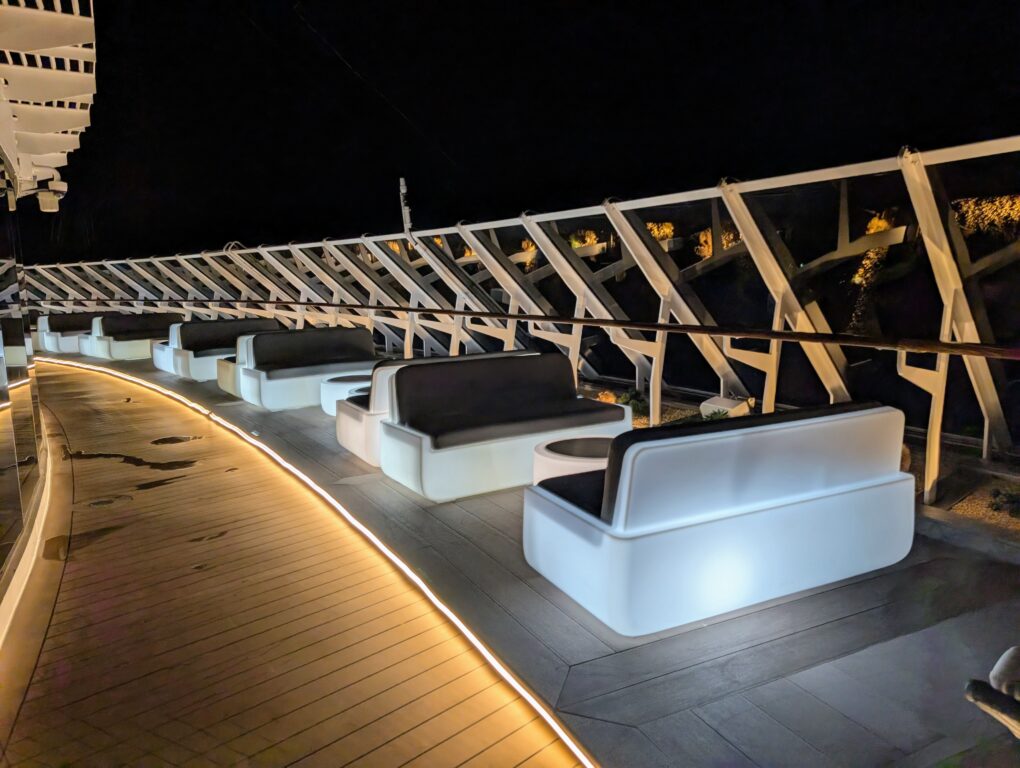 Lighted seating glows at night in The Yacht Club Lounge aboard the MSC Seascape