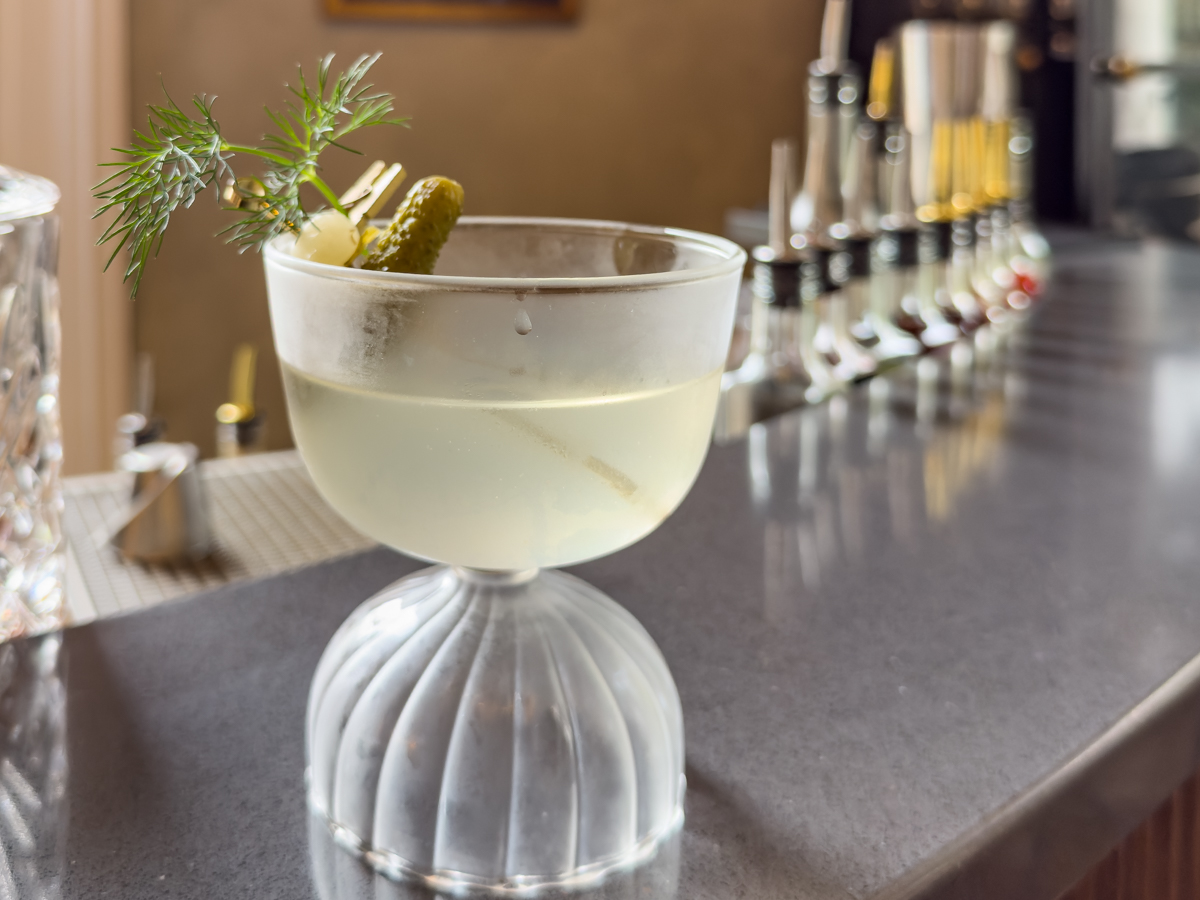 Dirty Dill Martini cocktail with garnish served in The Parlor at Heights House Hotel, Raleigh, North Carolina.