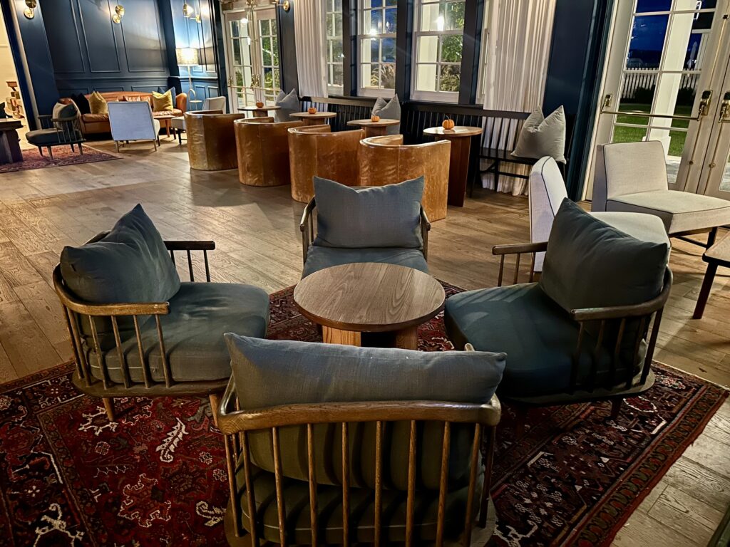 Interior featuring denim blue and caramel furnishings of The Library lounge at the Lake House on Canandaigua.