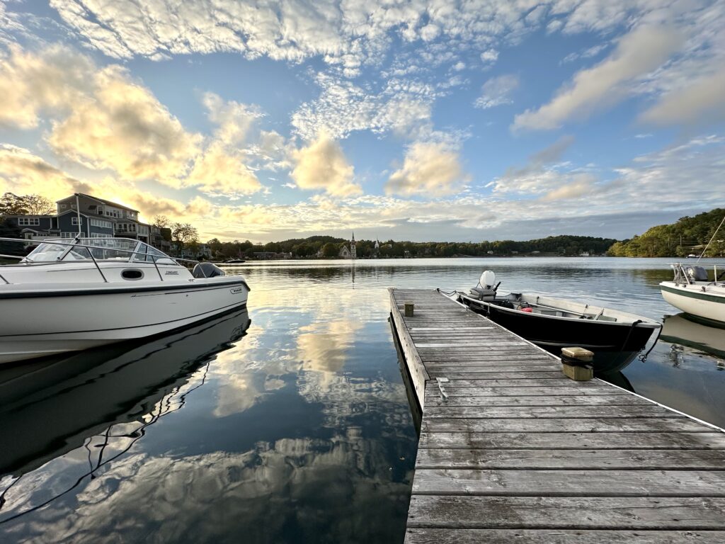 Boats at evening golden hour reflected in Mahone Bay, a stop along the Nova Scotia Chowder Trail road trip