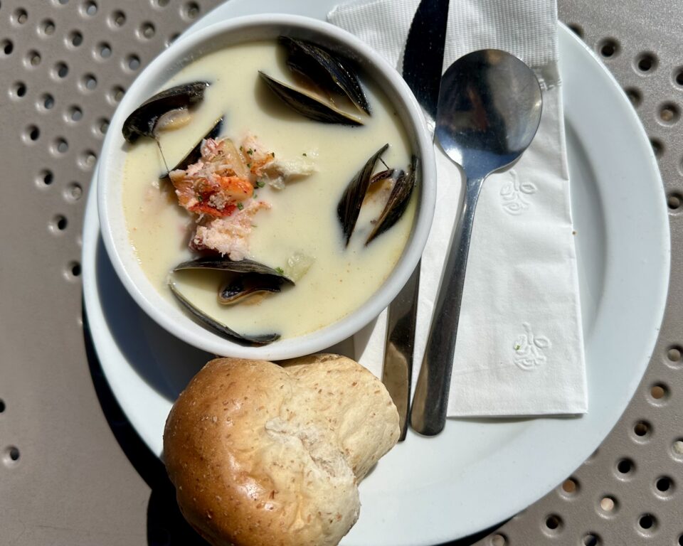 Bowl of chowder with lobster and mussels and a popover style biscuit at Evans, a stop on the Nova Scotia Chowder Trail road trip