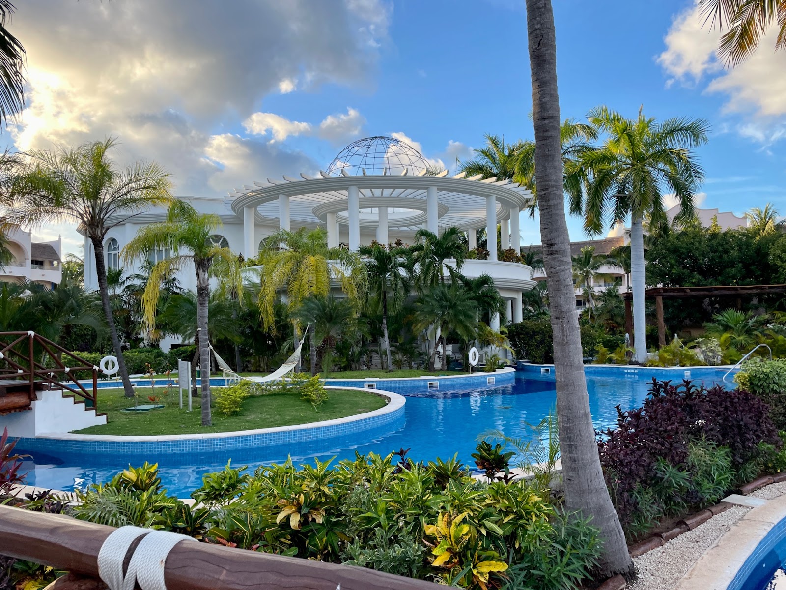 White buildings, blue pools and green tropical foliage at Excellence Riviera Cancun adults-only all-inclusive resort