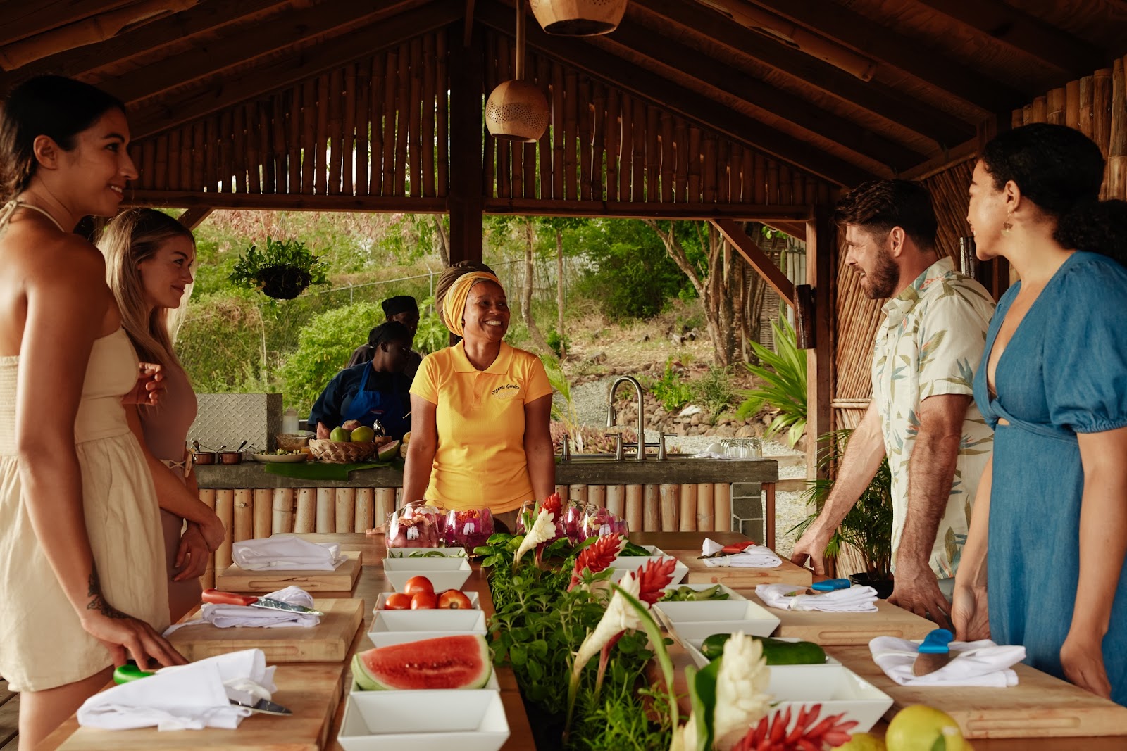 Woman gathered around a wooden table with fruit on it at Body Holiday adults-only all-inclusive resort St Lucia