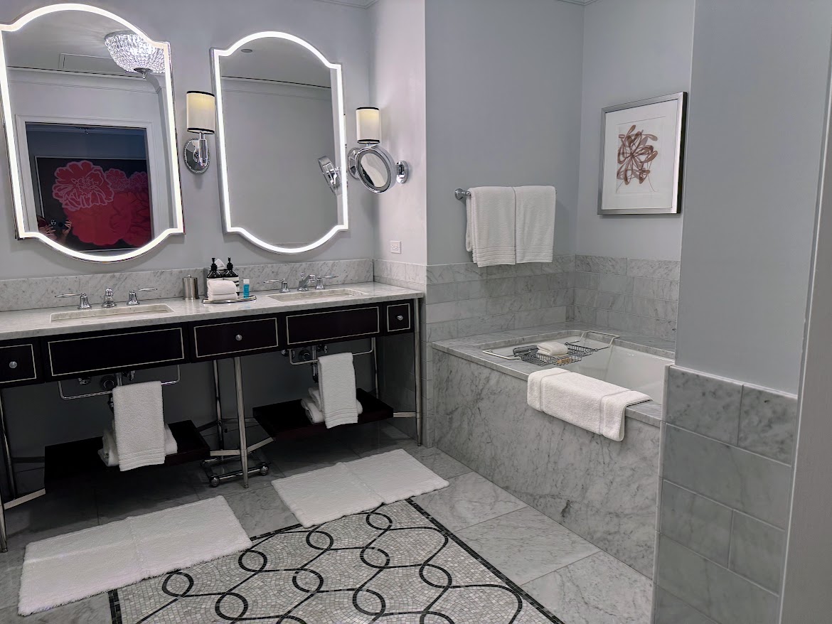 The bathroom at The Waldorf Astoria Chicago includes a deep soaking tub and a double vanity.