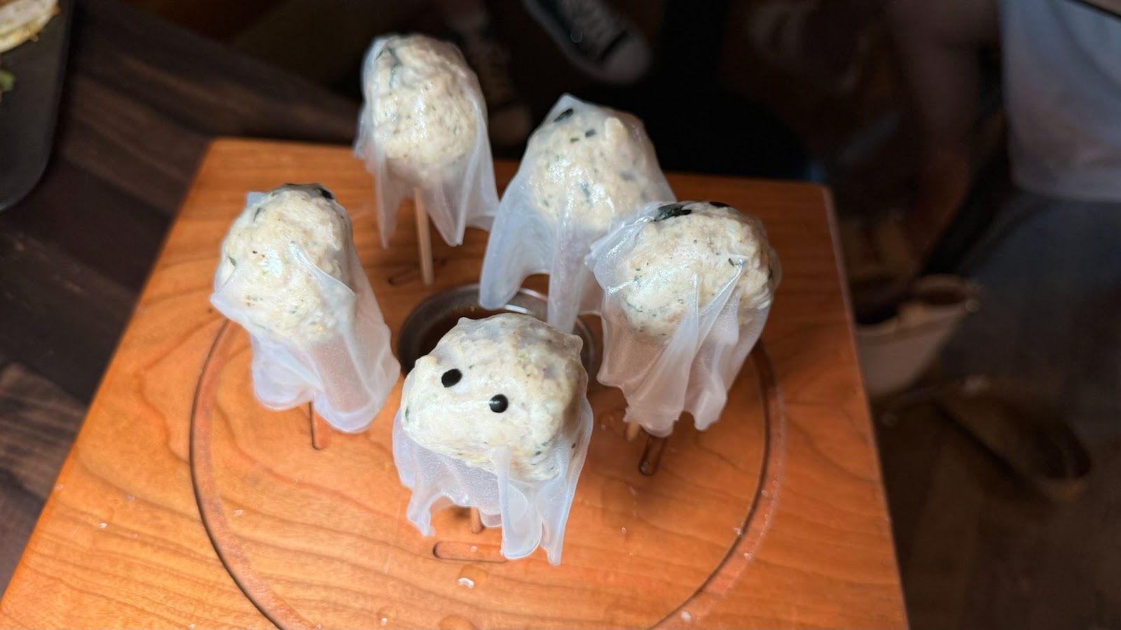 Rice paper draped over balls of pork on skewers inside of a wooden display box at a Halloween bar in Orlando, known as Jock Lindsey's Halloween Hangar Bar