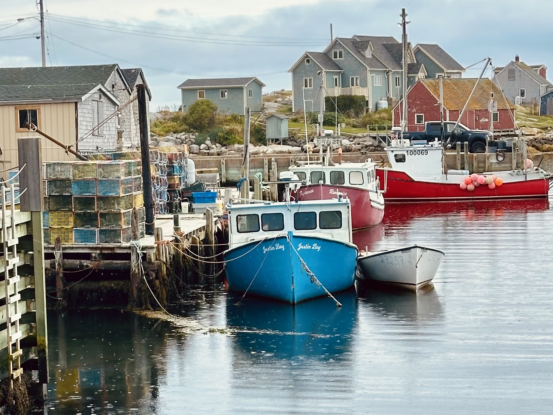 Blue and red fishing boats in Peggy's Cove, a Nova Scotia Chowder Trail pit stop.