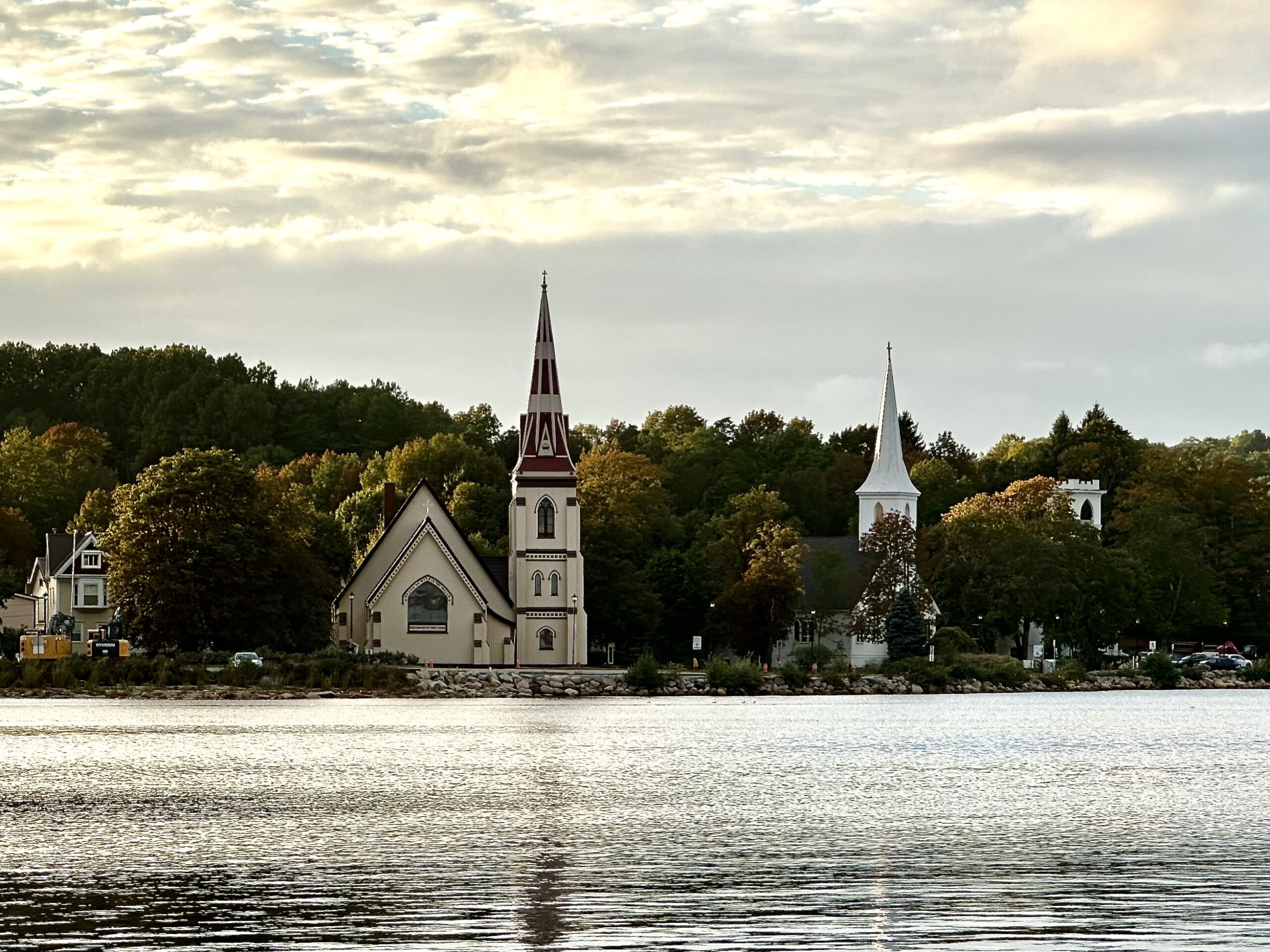 Three churches of Mahone Bay in Nova Scotia as viewed across the water at dusk.