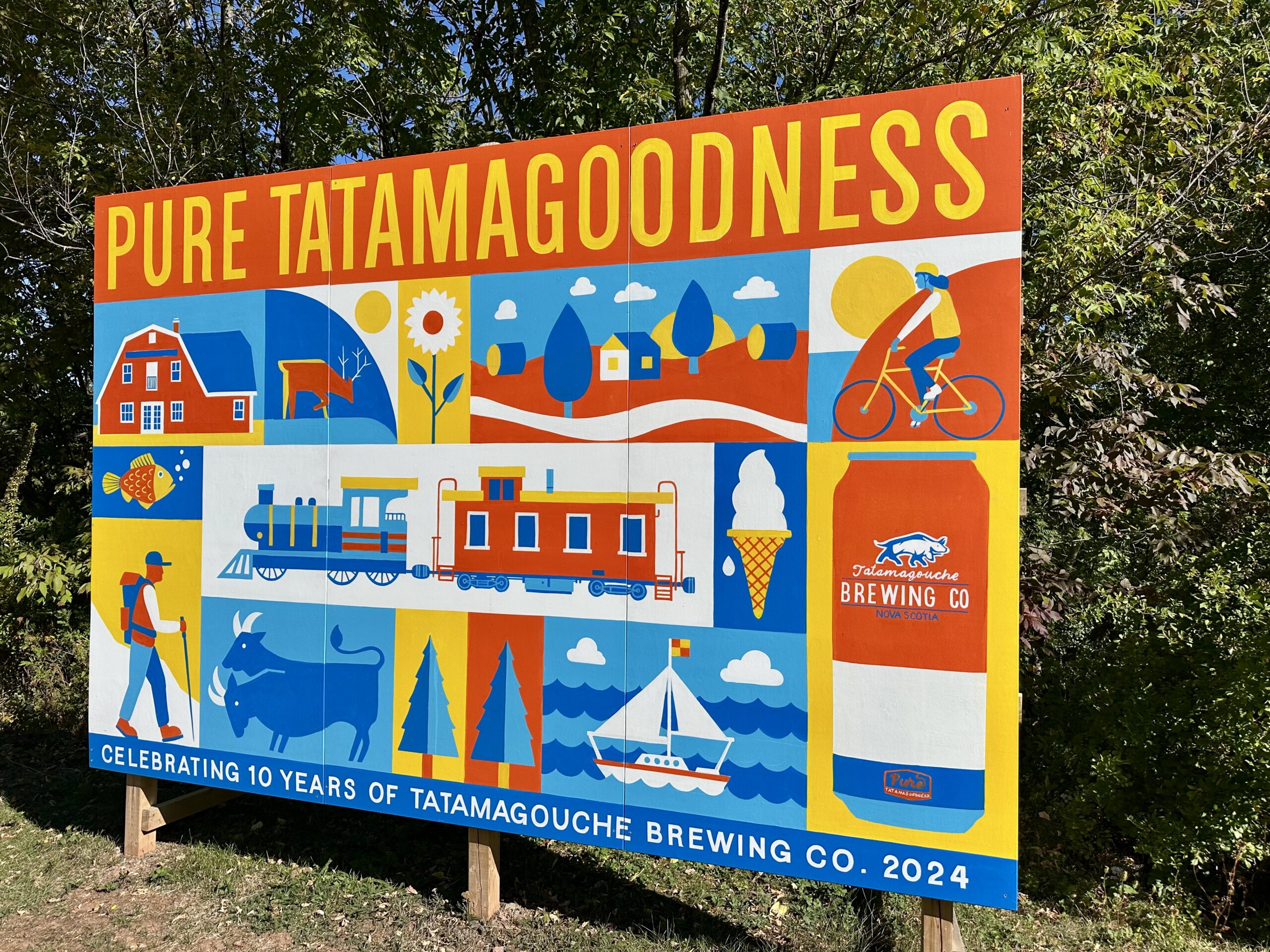 Blue, yellow and red mural celebrating the attractions in Tatamagouche, Nova Scotia.