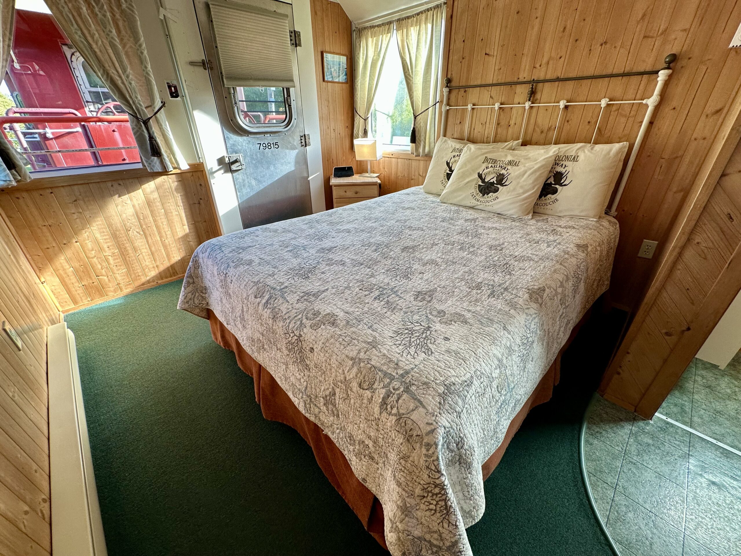 Queen bedroom in a restored train caboose at the Train Station Inn, a lodging and dining establishment in Tatamagouche, Nova Scotia.