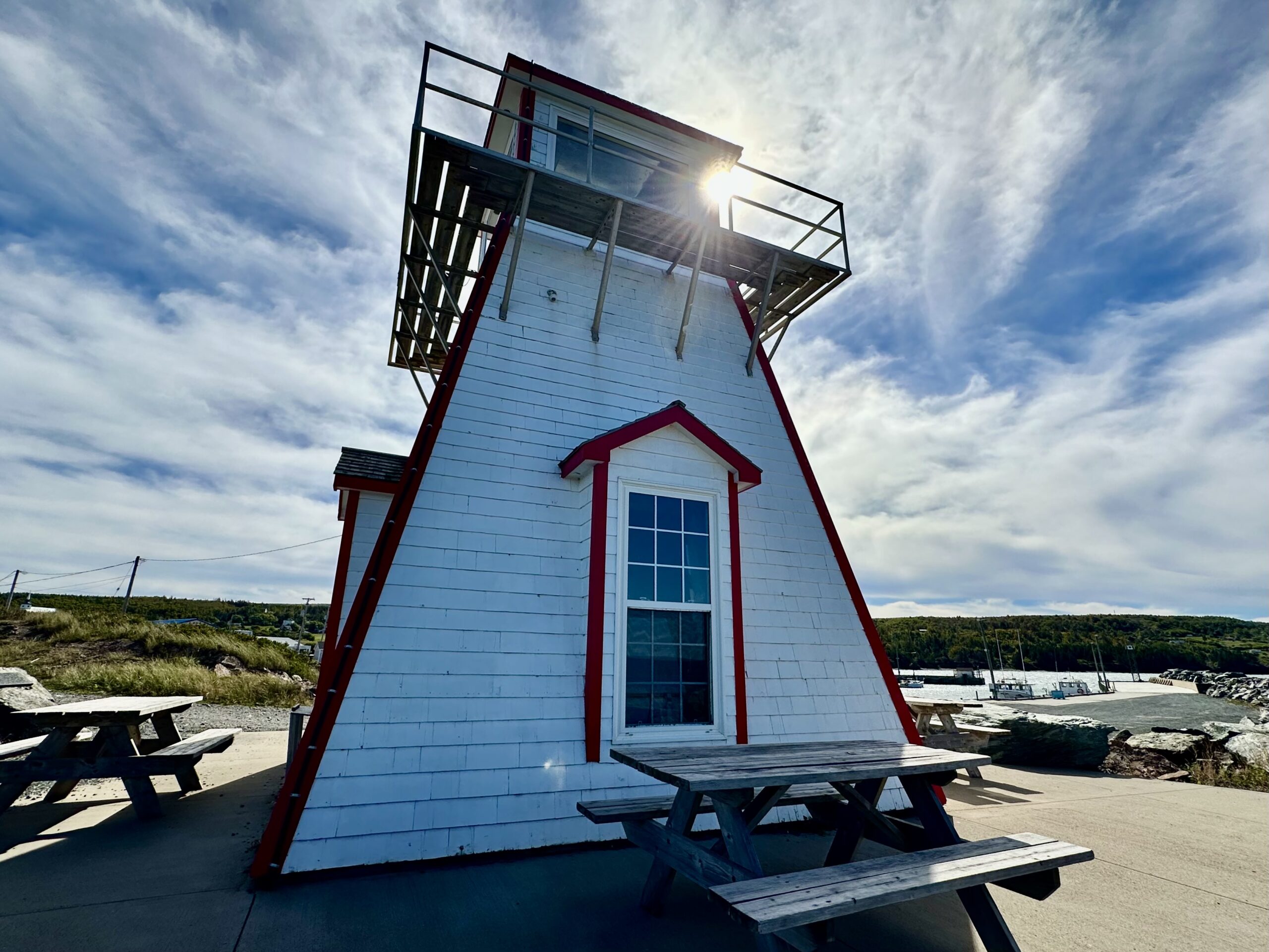 Morning sun behind the Arisaig Lighthouse, a Chowder Trail attraction in Nova Scotia.