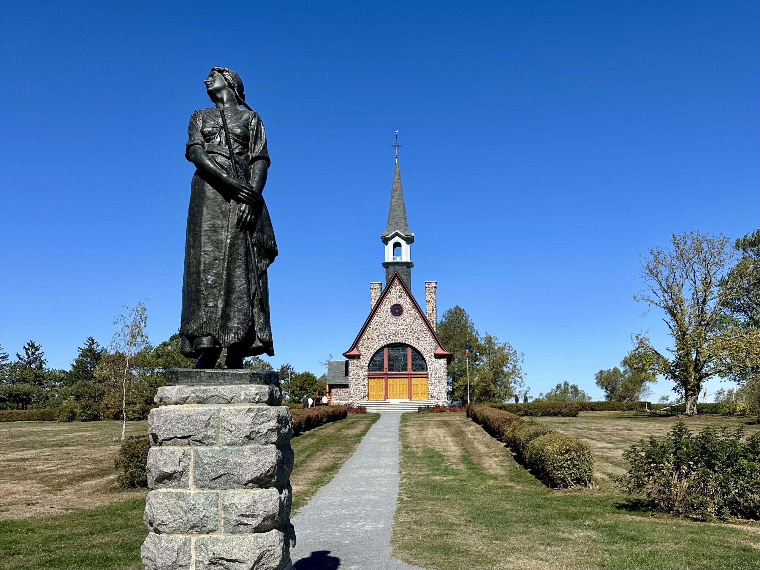 Statue of Evangeline and memorial church at the Grand Pre National Historic Site in Nova Scotia.