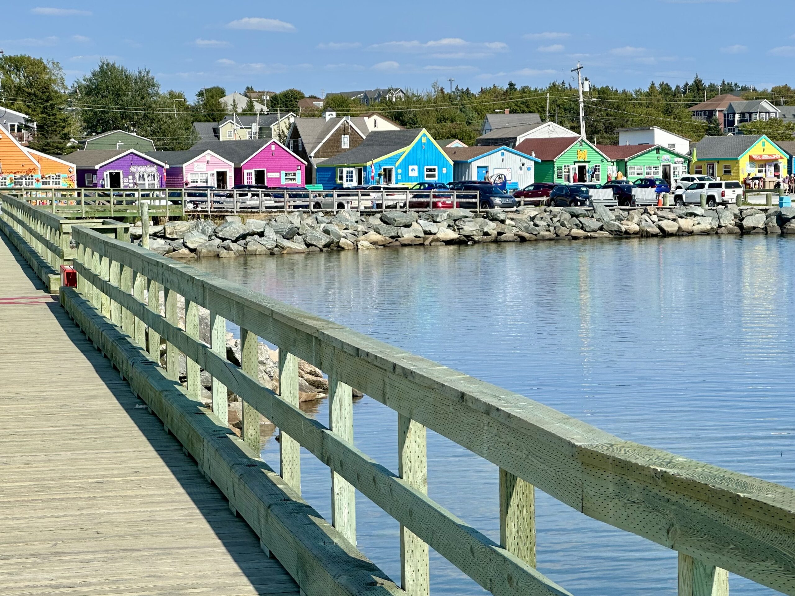 Rainbow-hued souvenir huts in Dartmouth's Fisherman's Cove.