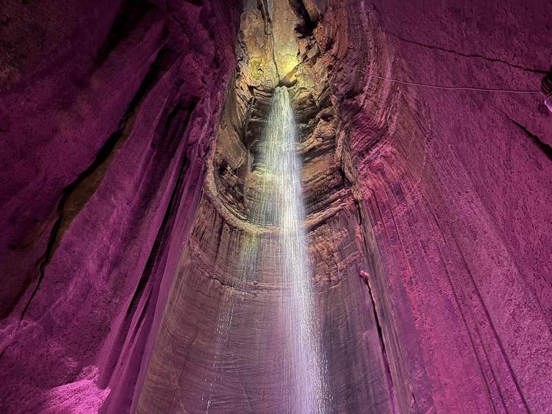 Underground waterfall at Ruby Falls, backlit in purple