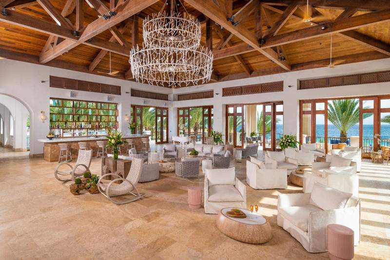 Open air bar with wood ceiling and white furniture